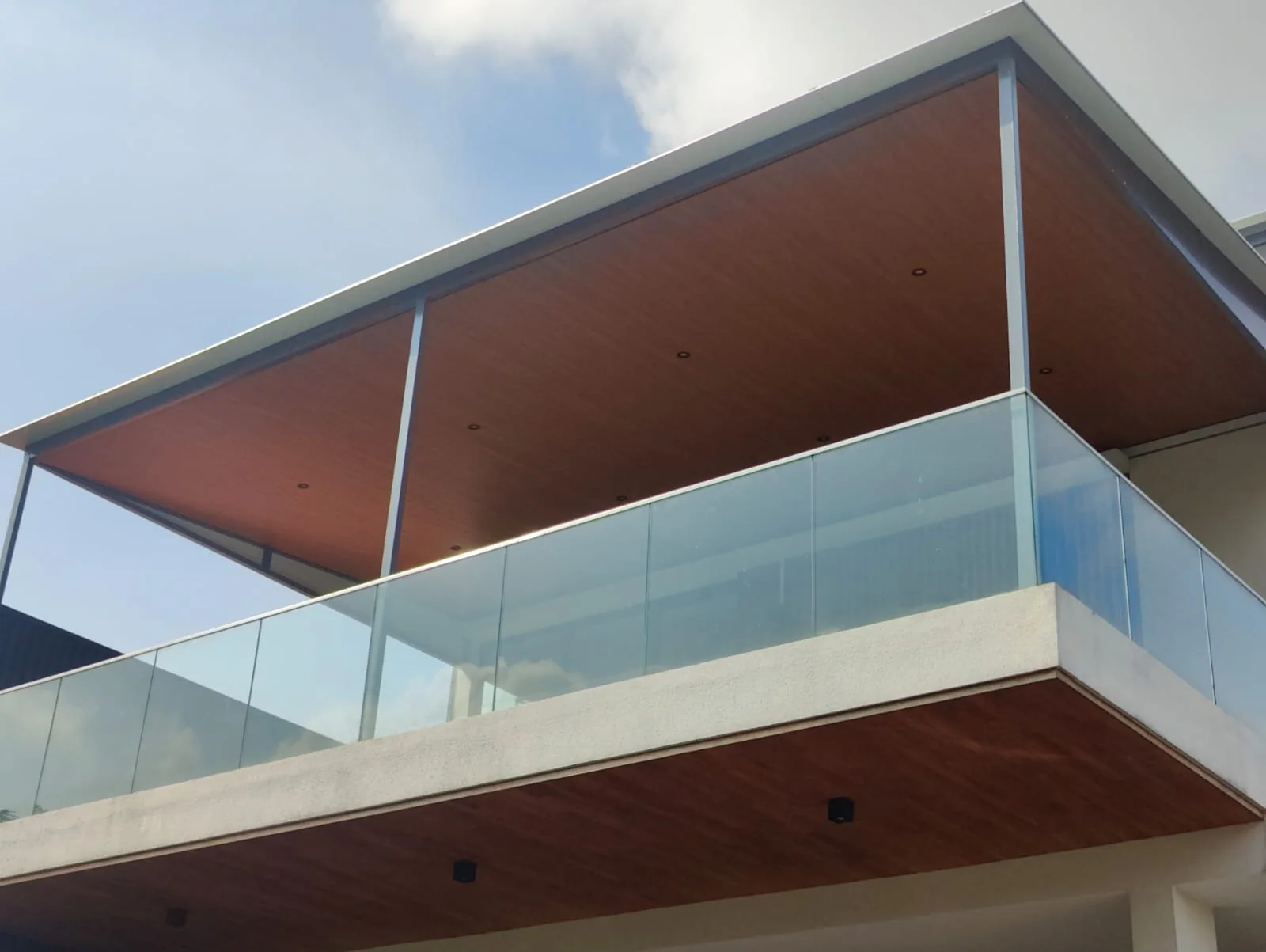 Roof over a glass rail, aluminium composite panel roofing installed by Exterior Design in Singapore