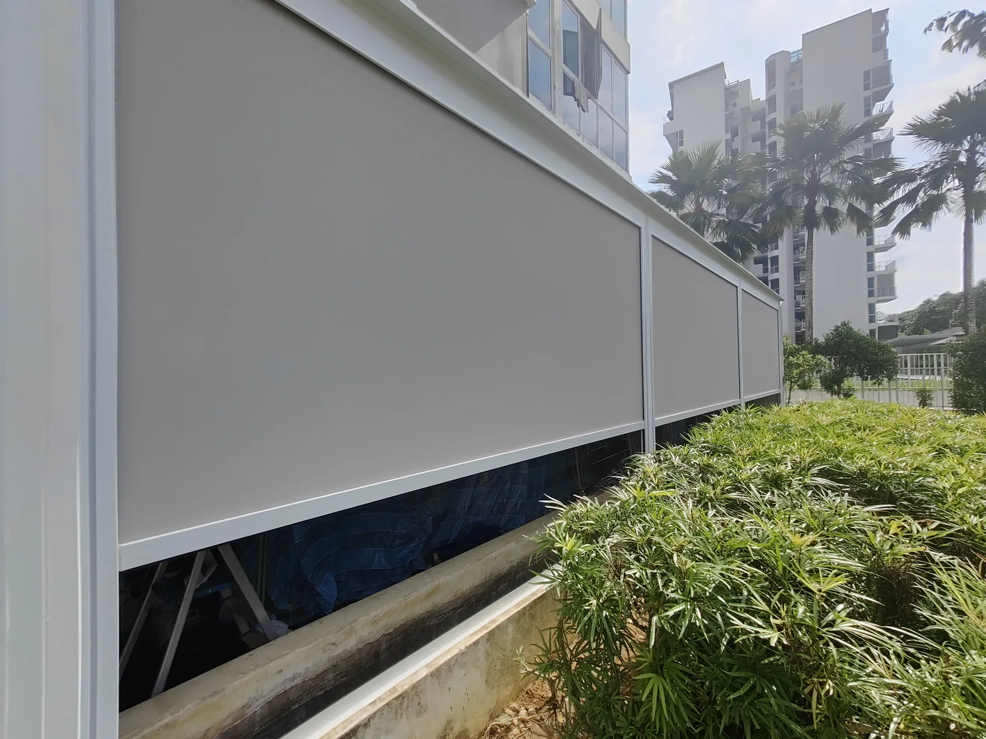 Along the hedge, ZipNice zip blinds installed by Exterior Design in Singapore